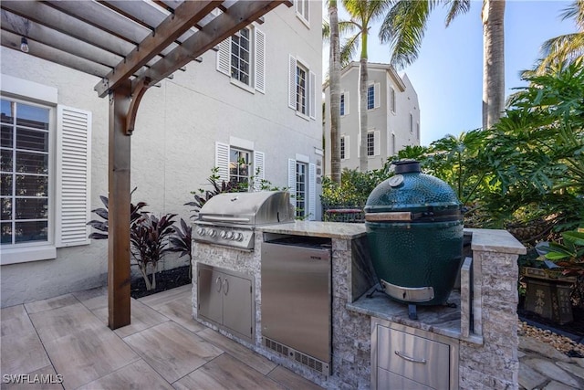 view of patio featuring a pergola, area for grilling, and a grill