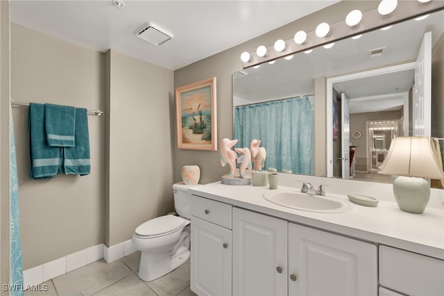 bathroom featuring tile patterned flooring, vanity, and toilet