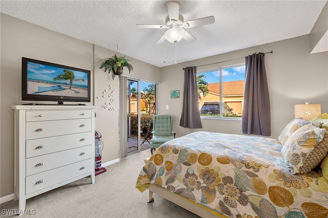 carpeted bedroom featuring a textured ceiling, access to outside, and ceiling fan