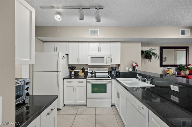 kitchen with white cabinetry, sink, rail lighting, white appliances, and light tile patterned floors