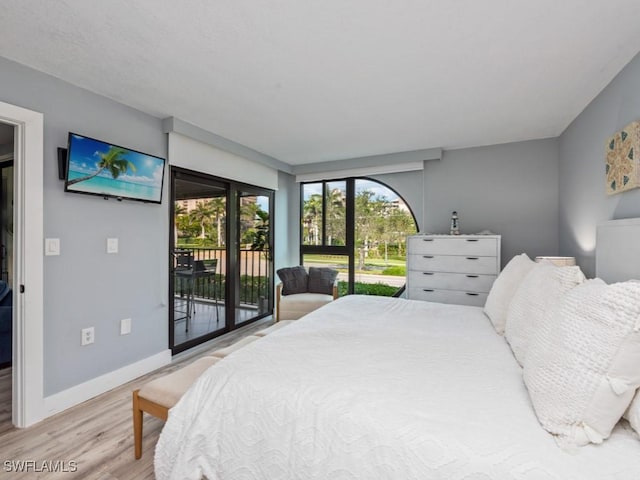 bedroom featuring light hardwood / wood-style flooring and access to outside