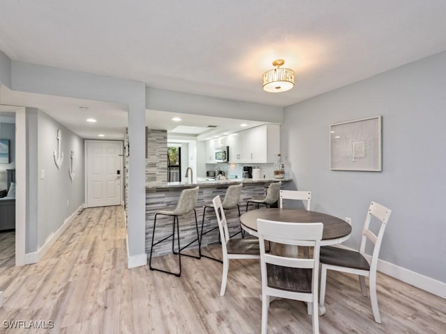 dining area featuring light wood-type flooring