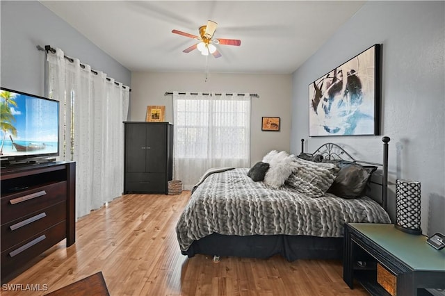 bedroom featuring a ceiling fan and light wood finished floors