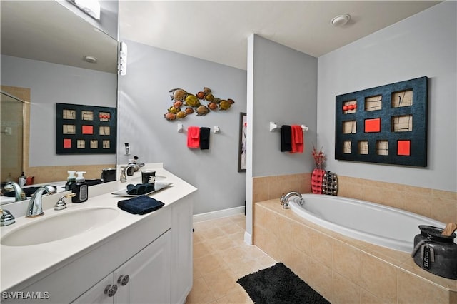 bathroom featuring a garden tub, tile patterned floors, baseboards, and vanity