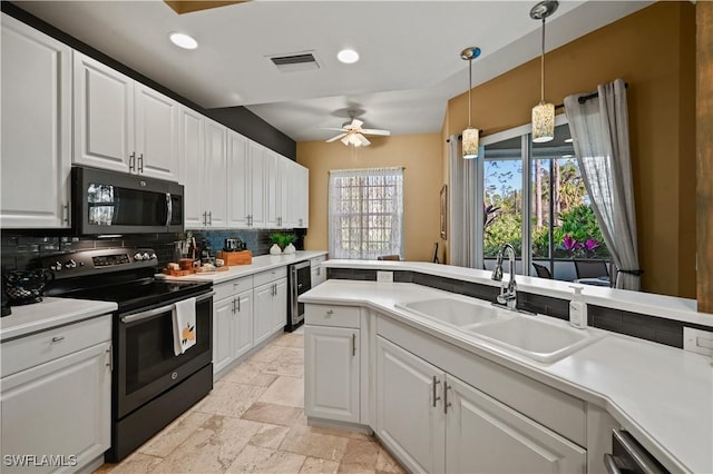 kitchen featuring light countertops, appliances with stainless steel finishes, a sink, and white cabinetry