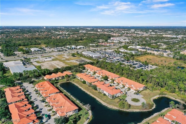 drone / aerial view featuring a water view and a residential view