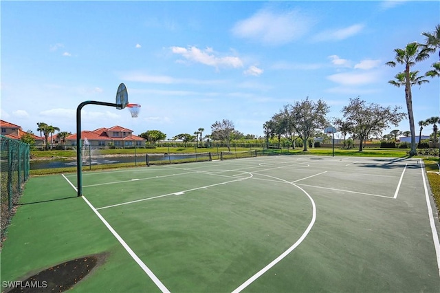 view of basketball court featuring community basketball court and fence