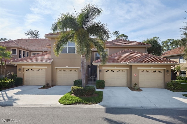 mediterranean / spanish-style house with a garage