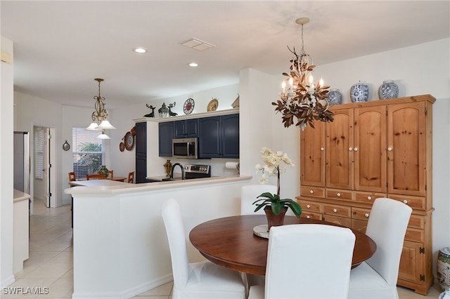 dining room featuring a notable chandelier and light tile patterned floors