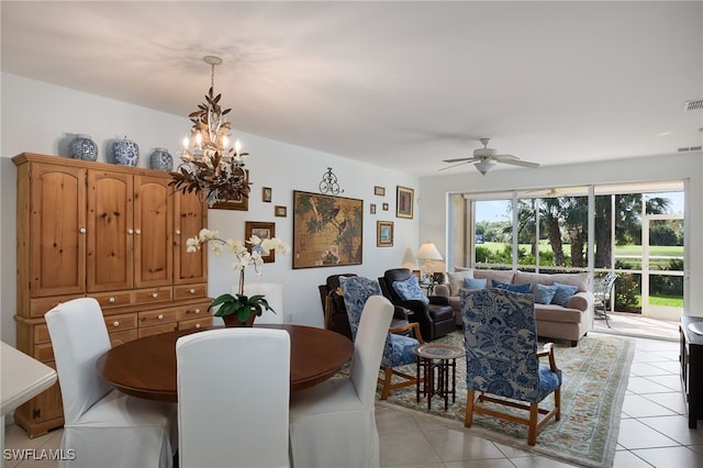 tiled dining space with ceiling fan with notable chandelier