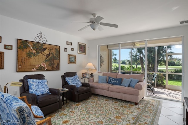 tiled living room with a wealth of natural light and ceiling fan