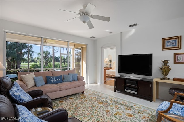 tiled living room featuring ceiling fan