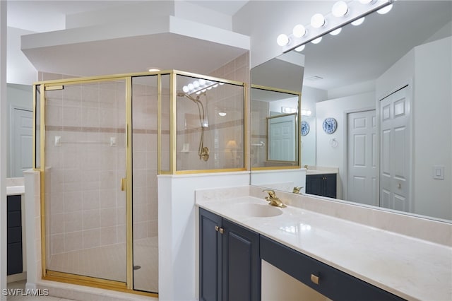 bathroom with vanity and a shower with shower door