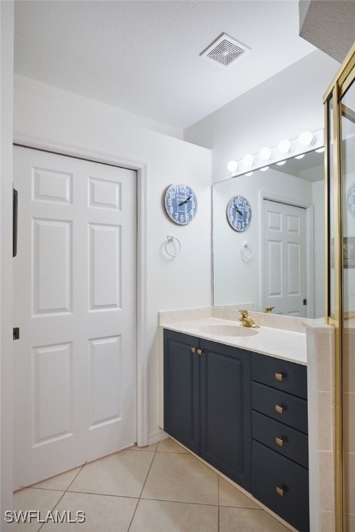 bathroom with tile patterned floors and vanity