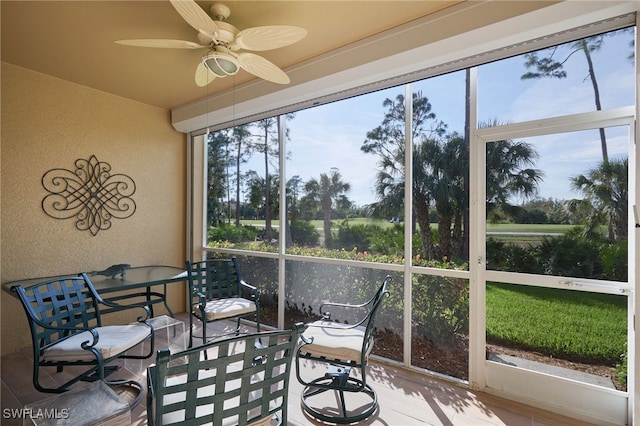 sunroom featuring ceiling fan