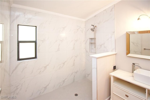 bathroom with tiled shower, vanity, and crown molding