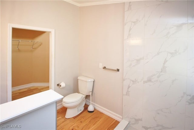 bathroom with hardwood / wood-style floors and toilet