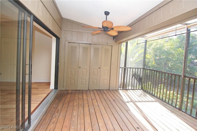 unfurnished sunroom featuring ceiling fan and vaulted ceiling