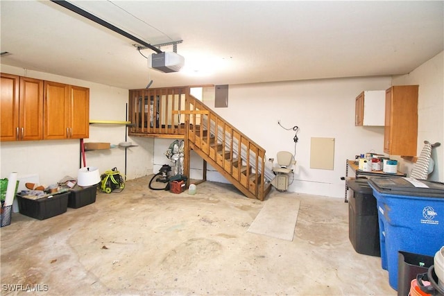 garage featuring electric panel and a garage door opener