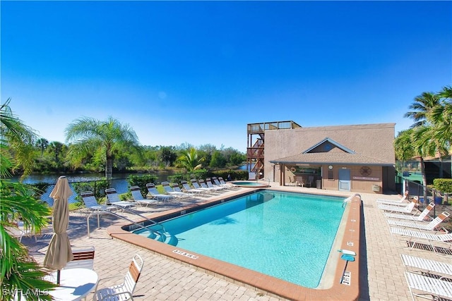 view of swimming pool featuring a patio area and a water view