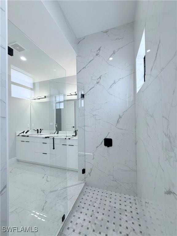 bathroom with vanity and a shower with shower door