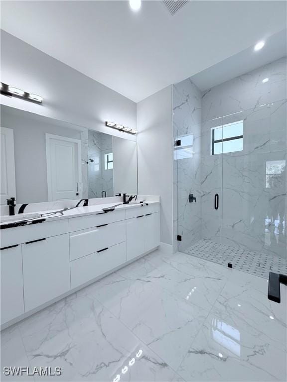 bathroom featuring vanity and an enclosed shower