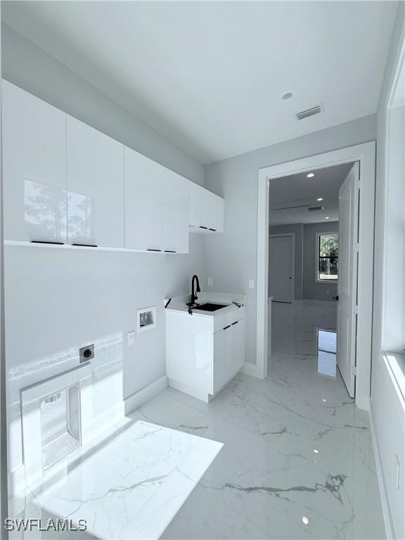 laundry area with cabinets, washer hookup, electric dryer hookup, and sink