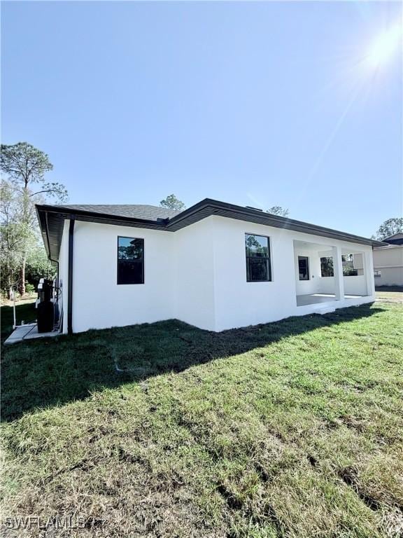 view of side of home with a lawn