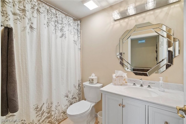 bathroom featuring vanity, curtained shower, and toilet