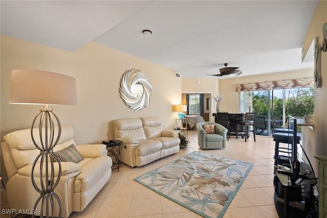 tiled living room featuring ceiling fan