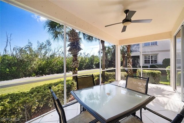 sunroom / solarium with a healthy amount of sunlight and ceiling fan