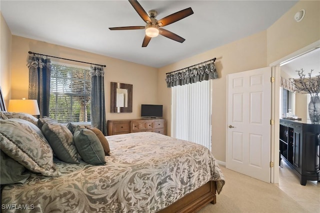 bedroom with ceiling fan and light colored carpet