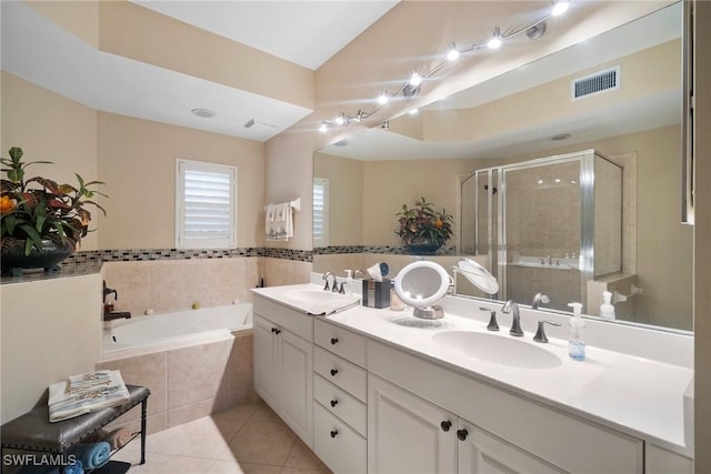 bathroom featuring tile patterned flooring, shower with separate bathtub, and vanity