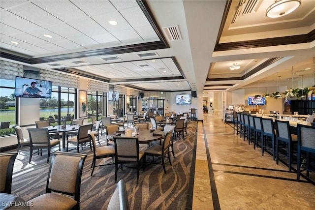 dining space featuring ornamental molding and coffered ceiling