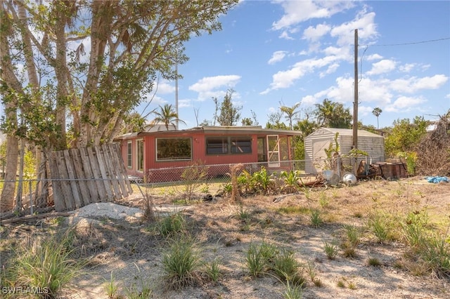 rear view of property with a shed