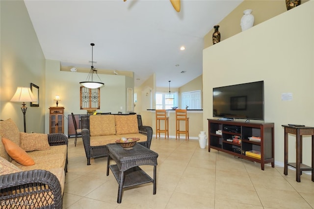 living room featuring light tile patterned floors, ceiling fan, and lofted ceiling