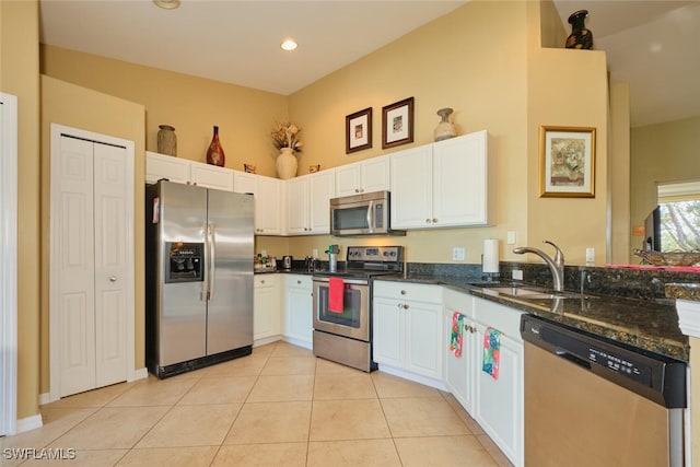 kitchen featuring white cabinetry, sink, appliances with stainless steel finishes, and dark stone counters