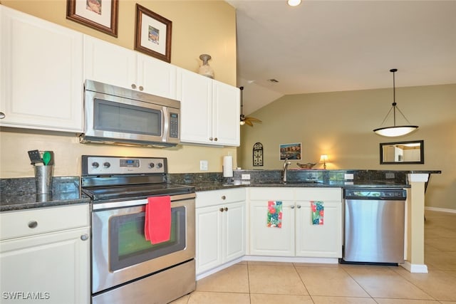 kitchen featuring white cabinets, kitchen peninsula, stainless steel appliances, and vaulted ceiling