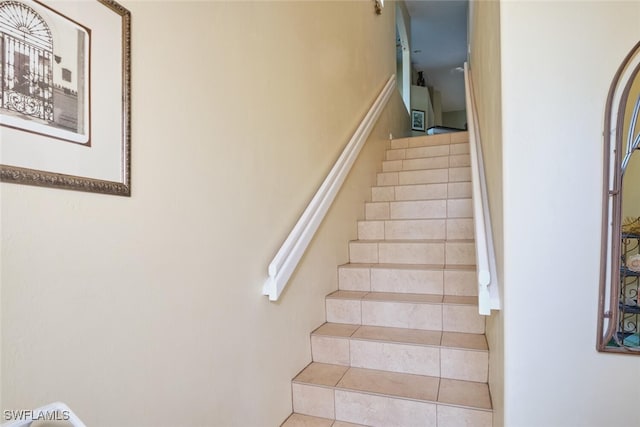 staircase with tile patterned floors