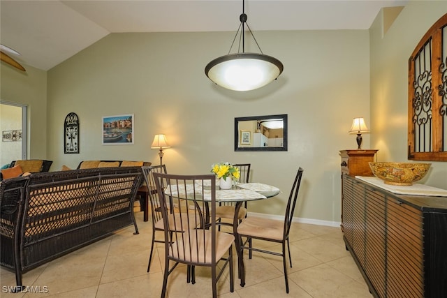 tiled dining room with lofted ceiling