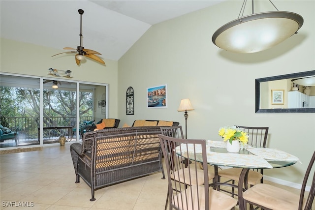 tiled dining space featuring ceiling fan and lofted ceiling