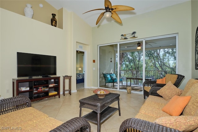 tiled living room with ceiling fan and vaulted ceiling