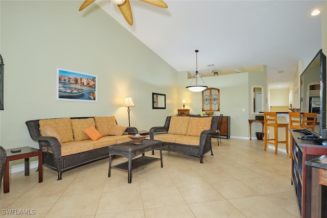 living room featuring ceiling fan, light tile patterned flooring, and vaulted ceiling