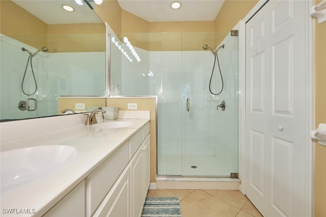 bathroom with tile patterned floors, vanity, and walk in shower