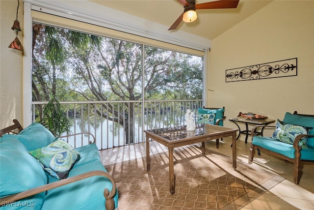 sunroom featuring a water view, ceiling fan, and lofted ceiling