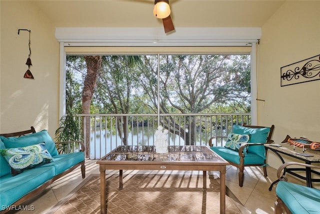 interior space featuring ceiling fan, a water view, and an outdoor hangout area