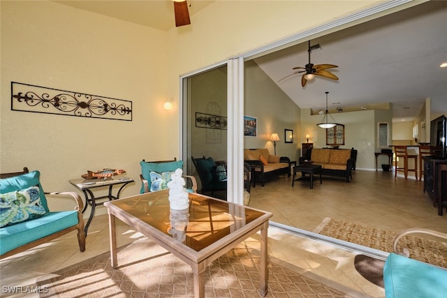 interior space with tile patterned floors, ceiling fan, and high vaulted ceiling