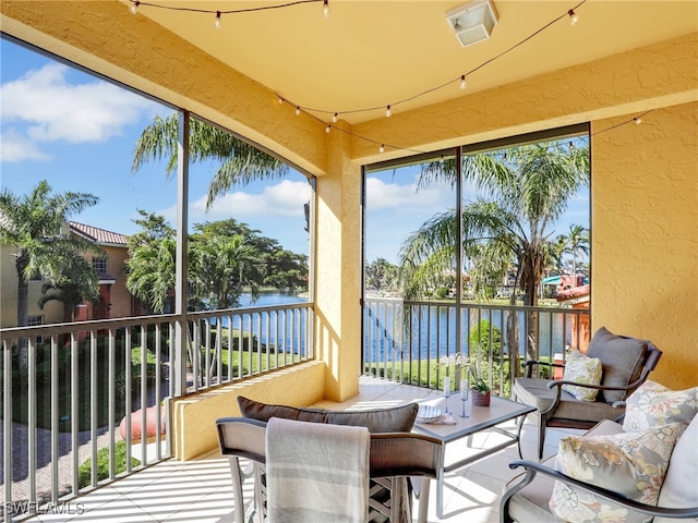 sunroom / solarium with a water view