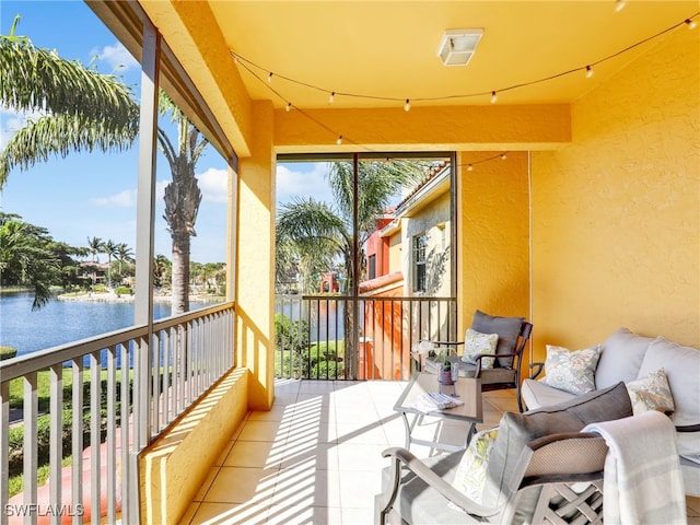 sunroom / solarium featuring a water view