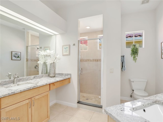 bathroom featuring tile patterned floors, a shower with door, toilet, and vanity